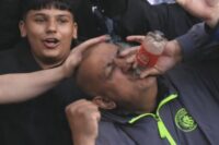 Man City fans mock Arsenal with viral ‘bottle’ gesture at Chelsea as title race heats up