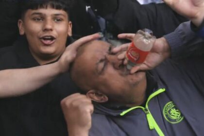 Man City fans mock Arsenal with viral ‘bottle’ gesture at Chelsea as title race heats up